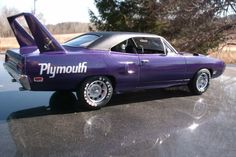 a purple car with the word plymouth written on it