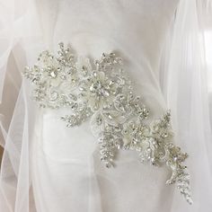 Pure hand beaded sewn silver crystal and rhinestone beaded bodice applique Size for one piece is about 16X44cm Gorgeous for wedding, couture design, bridal gown straps ... Back to rhinestone section https://www.etsy.com/shop/lacetime/items?ref=seller-platform-mcnav&section_id=15471438 my shop link: http://www.etsy.com/shop/lacetime ------------------------------------------------------ ---------------------------------------------------------------- ------------------------------------------ White Rhinestone Bridal Belt, Silver Embellished Bridal Belt, Embellished Silver Bridal Belt, White Crystal Bridal Belt With Rhinestones, White Crystal Bridal Accessories With Rhinestones, Embellished Crystal Bridal Belt, Fitted Crystal Embellished Bridal Belt, Fitted Crystal Bridal Belt Embellished, Embellished Fitted Bridal Belt