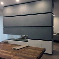 a modern living room with wood flooring and white walls