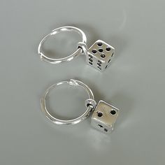 A PAIR of sterling silver hoops. Comes with a detachable dice charm. The charm is multipurpose and can be used with a neck or bracelet chain too. Dimension: Hoop- 12x1 mm Charm: 5 x8 mm Drop length- 19 mm These earrings are made of real 925 hypoallergenic sterling silver. Please let me know if you want the piece in a gift box. I can write out a message from you to the receiver if needed. Please be free to contact me at... bhavnakwintra1956@gmail.com More hoops: https://www.etsy.com/your/shops/Th Hoop Earring With Charm, Nickel-free Silver Dangle Huggie Earrings, Silver Nickel-free Dangle Huggie Earrings, Silver Dangle Huggie Earrings Nickel-free, Adjustable Sterling Silver Huggie Earrings, Silver Huggie Earrings With Charms, Nickel-free Sterling Silver Huggie Earrings As Gift, Silver Charm Hoop Earrings, Silver Dangle Hoop Earrings With Charms