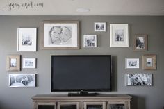 a flat screen tv sitting on top of a wooden entertainment center in a living room