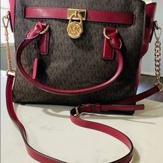 Michael Kors Hamilton Colorblock Signature Brown/Mulberry I Have Carried It Twice Maybe 3 Times Purchased Used From Another Online Retailer. Just Sitting In My Closet. Colors Are Brown/Mulberry With Gold Hardware. Thanks For Looking! (Mulberry- Dark Red, Burgandy, Maroon, Wine Color Type) *12-3/4" W X 9" H X 5-1/2" D * Interior Features Zip Pocket, 2 Slip Pockets And Key Fob * 5"L Double Handles; Adjustable Chain/Leather Shoulder Strap *Zip Top Closure * Exterior Features A Signature Key And Lock * Gold-Tone Hardware *Signature Mk Monogram Logo *Saffiano Leather Michael Kors Handbags Black, Mk Monogram, Key And Lock, Studded Handbag, Closet Colors, Michael Kors Mercer, Tan Handbags, Michael Kors Satchel, Black Satchel