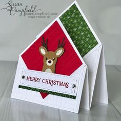 a close up of a christmas card with a deer in the corner and merry christmas written on it