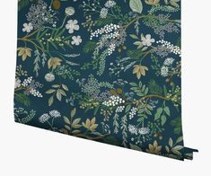 a blue wallpaper with white flowers and green leaves on the outside, as well as gold foil