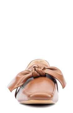 A large scale bow adds fun detail to a square, apron toe loafer with versatile style. 0.71" heel Square apron toe Bow detail Slip-on Manmade upper and sole Imported Chic Pointed Toe Loafers With Bow, Leather Flat Loafers With Bow, Flat Heel Loafers With Bow For Workwear, Flat Leather Loafers With Bow, Formal Bow Loafers For Fall, Flat Bow Loafers For Workwear, Spring Bow Loafers For Work, Flat Bow Loafers For Work, Square Apron