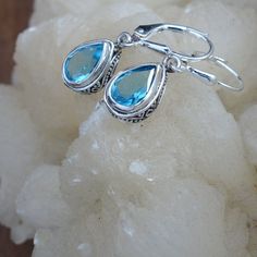 Elegant Blue Topaz Earrings; 925 Sterling Silver; Secure Backs; Drop and Dangle; Genuine Gemstone Earrings; Handmade Jewelry; Gift for Her Swiss Blue Topaz Earrings. Handmade in Bali Length 1.14 inch Stone Size 9x6mm 🎁Great as a gift for yourself or someone else. Free Gift Packaging -- just let us know! Please message us with any questions -- we are happy to help!! 💙Blue Topaz Metaphysical Properties 💙 Inspires creativity 💙 Promotes calm and aids in meditation 💙 Increases psychic abilities Silver Teardrop Topaz Earrings, Silver Topaz Teardrop Earrings, Silver Topaz Dangle Earrings, London Blue Topaz Jewelry, Blue Topaz Jewelry, Topaz Jewelry, Blue Topaz Earrings, Garnet Jewelry, Handmade Jewelry Gift