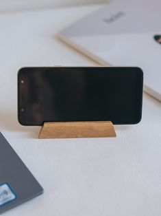 a cell phone sitting on top of a wooden stand