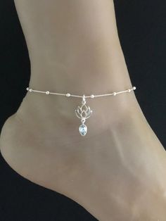 Genuine Lotus Blue Topaz AnkletMinimalist and Dainty Rolo Beaded Lotus Blue Topaz Charm AnkletANKLET FEATURES:Metal:  All components are made from solid .925 Sterling Silver Model is wearing 10" in length  solid .925 Sterling Silver Rolo Bead ChainChain Length:  9 inch + 1 inch extension Measurement:  Natural Lotus Blue Topaz PendantHeight: 20MM Width:  14MMYour Dainty Rolo Beaded Lotus Blue Topaz Anklet will arrive in a gift box, beautifully wrapped and ready for giftingPlease send me a message Silver Dainty Anklets For Wedding, Adjustable Sterling Silver Anklets For Wedding, Adjustable Sterling Silver Wedding Anklets, Silver Adjustable Spiritual Anklets, Wedding December, Beaded Ankle Bracelets, Silver Model, Beaded Ankle, Heart Anklet