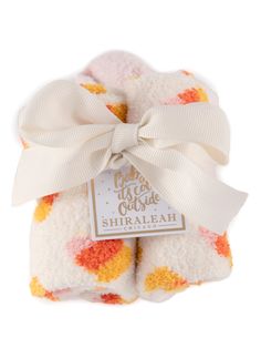 two white and orange blankets with a bow