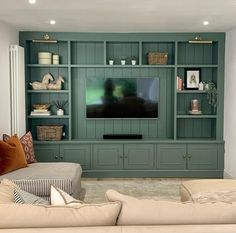 a living room filled with furniture and a flat screen tv on top of a wooden entertainment center