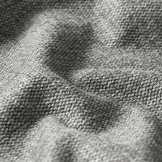 the texture of a knitted blanket is shown in black and white, as well as light gray colors