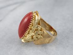 This is a beautiful, Victorian-inspired piece! Organic forms of textured 18k gold frame the deeply saturated coral, while the multi-prong setting holds the cabochon safely in place. The polish on this sumptuous coral is excellent, and makes this ring elegant enough for evening wear! Metal: 18K Yellow Gold Gem: Coral Gem Measurements: 19.4 x 10.4 mm, Oval Ring Size: 6.75 Marks: "750" Stamped on the inside band Formal Coral Ring, Elegant Coral Ring Jewelry, Elegant Coral Rings For Anniversary, Formal Coral Jewelry With Cabochon Details, Formal Coral Jewelry With Cabochon, Coral Elegant Wedding Rings, Elegant Coral Wedding Rings, Red Coral Ring, Men Styling