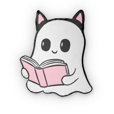 a pillow with a cat reading a book