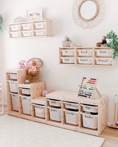 a child's playroom with toys and storage bins