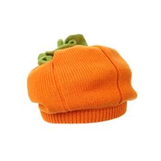 an orange knitted hat with a green bow on the brim and two leaves