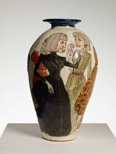 an artistic vase with two women painted on it's sides, sitting on a white surface