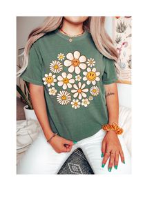 Step into the warmth of style and embrace the carefree vibes with our "Daisy Days Sunshine Bloom Tee." This delightful t-shirt is a celebration of the spirit of warmer days and sunny moments. Crafted from soft, breathable cotton, it provides comfort that matches its sunny disposition. The cheerful design features a vibrant daisy in full bloom, symbolizing the positivity and brightness that comes with the arrival of warmer weather. The playful colors and lively imagery make it a perfect addition Trendy Floral Print T-shirt For Day Out, Hippie Soft-washed Crew Neck Top, Hippie Crew Neck Soft-washed Top, Soft-washed Hippie Crew Neck Top, Hippie Soft-washed Relaxed Fit Tops, Hippie Style Soft-washed Relaxed Fit Top, Cute Crew Neck T-shirt For Day Out, Spring Daisy Print Cotton Tops, Spring Cotton Daisy Print Tops