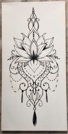 a black and white drawing of a lotus flower on a piece of paper with an intricate design