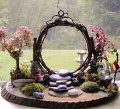 a garden with rocks and flowers on a table in front of a glass door window