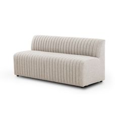 a white couch sitting on top of a white floor