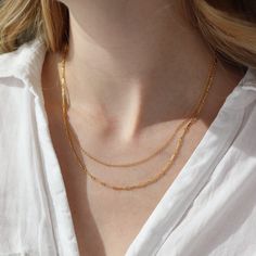 The Equinox Double Chain necklace instantly gives a pretty layered look. This layering necklace features two chains that come together to create a subtle statement, no untangling required. DETAILSAvailable in 14"- 15", 16"-17", and 18"-19" with longer chain measuring an additional 1" in lengthAvailable in 14k Gold Fill and Sterling SilverHypoallergenic, Nickel-Free, and Water Safe Multi-strand Figaro Chain Necklaces For Layering, Dainty Multi-strand Layered Necklace With Figaro Chain, Everyday Multi-strand Figaro Chain Necklace, Dainty Multi-strand Figaro Chain Necklace, Dainty Multi-strand Chain Necklace For Layering, Delicate Double Chain Layered Necklace, Minimalist Multi-strand Layered Chain Necklace, Minimalist Multi-strand Chain Necklace, Minimalist Layered Multi-strand Chain Necklace