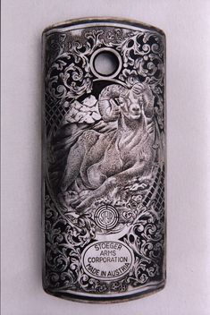 an antique lighter case with a deer and flowers on the front, engraved in silver