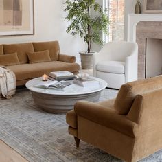 a living room with couches, chairs and a coffee table in front of a fireplace