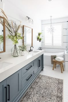 a large bathroom with two sinks and mirrors