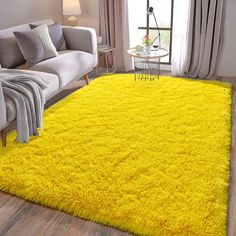 a living room with a yellow rug on the floor