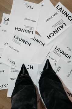 a person's feet on some white paper with black lettering