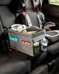 a car seat filled with food and drinks in the passenger's side area,