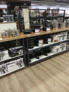 shelves with pots and pans on them in a store or other department's