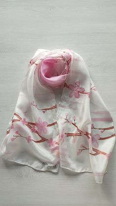 Immerse yourself in the beauty of spring with this hand-painted silk scarf, a unique masterpiece that captures the grace and elegance of cherry blossoms. Each stroke reflects the delicacy of the petals, creating an exquisite design that transforms this accessory into a true piece of wearable art. High Quality Material: Crafted from 8 pongee silk, soft and luxurious that adds a touch of elegance to any outfit. Exclusive Design: It is a unique creation, hand painted with precise details that highl Silk Scarf Painting, Hand Painted Silk Scarf, Painted Silk, Hand Painted Silk, The Grace, Silk Painting, Cherry Blossoms, Shawls And Wraps, Exquisite Design