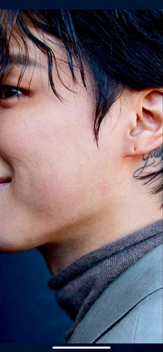 a close up of a person with ear piercings