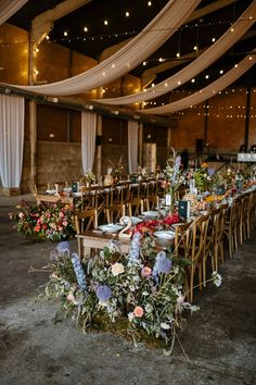 the tables are set up with flowers and greenery