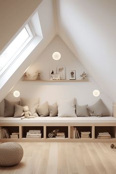 an attic bedroom with white walls and wooden flooring, built in bookshelves