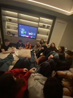 a group of people sitting in front of a tv