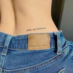 an american eagle tattoo on the back of a woman's stomach