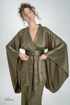 Indulge in the opulence of silk kimono pajamas, a sophisticated upgrade to your casual at-home attire. Drawing inspiration from the exquisite designs of traditional Japanese kimonos, our collection offers a fusion of comfort and elegance. Immerse yourself in the enduring allure of authentic Japanese traditions with our luxurious silk kimono line. ✂ About us: ♥ Est. 2017 ♥ Based in Lincolnshire, UK ♥ Handmade in Europe ♥ Small family run brand ♥ Handmade in Europe ♥ Sustainable and ethical production ♥ We support local craftsmanship ♥ Sizes for all body types ✂ About PJs: * Obi tie belt * Long wide kimono sleeves * Hidden side kimono pockets * Inside loops * High-waisted trousers *Trouser pockets * Silky Satin ✂ Shipping: * Fast UK delivery in 1 - 2 days * We ship worldwide! * Returns accep Kimono Pockets, Pyjamas Silk, Gown Aesthetic, Kimono Pajamas, Robe Silk, Silk Dressing Gown, Traditional Japanese Kimono, Satin Kimono, Trouser Pocket