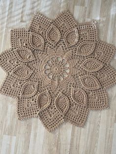 a crocheted doily is laying on the floor