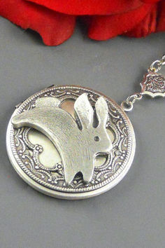 Large round sterling silver plated locket is embellished with sterling silver plated lacy filigree and bunny charm/rabbit.  Victorian style locket is hanging from silver chain. Antique Silver Locket Necklace With Charms, Silver Antique Locket Necklace With Charms, Antique Silver Pendant Locket Necklace Collectible, Handmade Antique Silver Pendant Locket Necklace, Vintage Silver Locket Necklace With Charms, Silver Vintage Locket Necklace With Charms, Handmade Antique Silver Locket Necklace As Gift, Vintage Silver Locket Necklace With Round Pendant, Victorian Silver Locket Necklace Gift