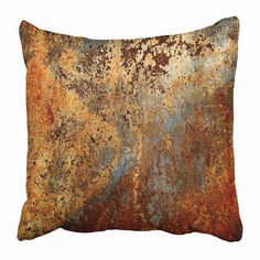 an orange and brown pillow with rust on it's side, against a white background