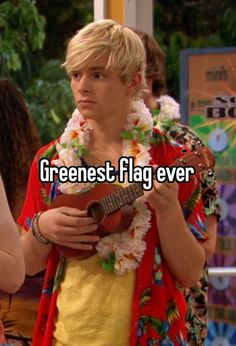 a person holding a ukulele with the words greenest flag ever