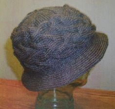 a knitted hat sitting on top of a wooden table