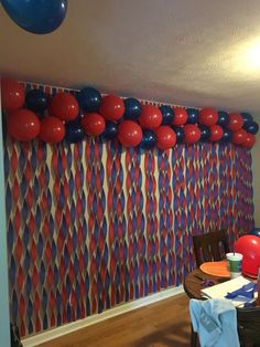 a party room with balloons and streamers on the wall