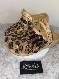 MyStyleMyWay's  custom crocs are designed for the perfect outfit, that special occasion, and "Just Because" you love blinged out crocs.  In the display shown we designed a pair of tan "Cheetah Print Design" classic crocs adding high quality colorful rhinestones. 🐆Each Rhinestone is individually and neatly placed to achieve the design.  🐆Rhinestones are added to the top and buttom trimming of the shoe.  🐆Personality Patch is applied to this design to add cuteness and personality.  🐆This design was personalized. 🐆The sports mode strap is also designed.   🐆This design do not have charms, charms can be added please contact us directly or visit our website www.MyStyleMyWay.co to view our charm selection.  🐆When making your purchase - You're making a purchase for the exact style shown. If Blinged Out Crocs, Bedazzled Crocs, Womens Clogs And Mules, Custom Crocs, Classic Crocs, Bling Design, Custom Bling, Clogs And Mules, Bling Shoes