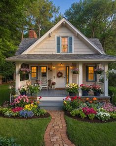 a white house with flowers in the front yard