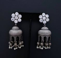 Gather compliments wearing this Indian jhumka earrings with flashy CZ ear studs. In faux diamond, ruby, emerald, and blue sapphire. Voluptuous shape. Very feminine and pretty! Tiny dangly metal balls and pearls finish the look. Earrings are cast metal, not stamped, so they look and feel substantial. find even more great earrings here: https://www.etsy.com/shop/boutiquebymaryam?section_id=22797814 Be sure to visit the rest of my shop here: https://www.etsy.com/shop/boutiquebymaryam All my jewelry Festive Traditional Dangle Crystal Earrings, Teardrop Jhumkas With Latkans For Gift, Fusion Style Drop Jhumkas As A Gift, Teardrop Jhumkas With Latkans As A Gift, Heavy Drop Jhumkas As Gift, Silver Jhumkas With Latkans For Anniversary, Silver Fusion Jhumkas For Anniversary, Silver Jhumkas For Anniversary And Diwali, Silver Bollywood Earrings For Gifts