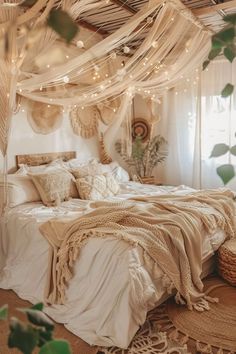 a bed with lots of pillows and blankets in a room that has lights strung from the ceiling