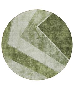 a round rug with an abstract design in green and white